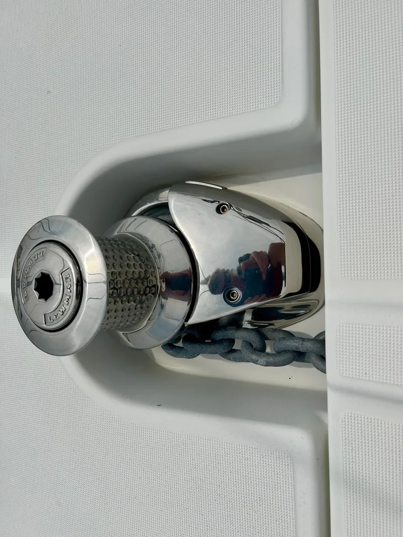 Slide: The Image of Anchor windlass on 2012 Jeanneau 50 DS yacht, featuring polished metal and chain. - 9