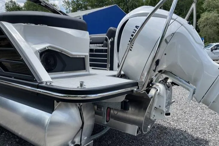 Slide: The Image of 2024 Bennington RFBASR boat with Yamaha outboard motor, rear view on gravel. - 10