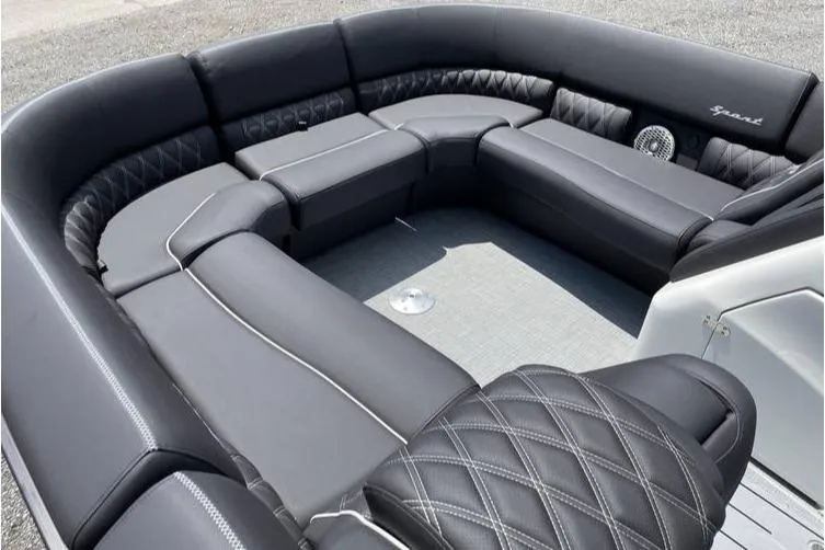 Slide: The Image of 2024 Bennington RFBASR boat interior with luxurious black seating and diamond stitching. - 2