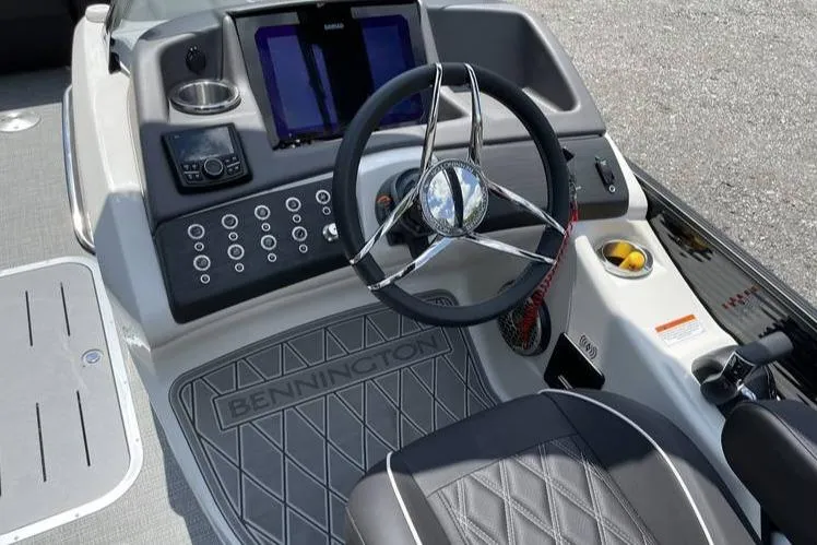 Slide: The Image of 2024 Bennington RFBASR boat dashboard with steering wheel and control panel. - 6