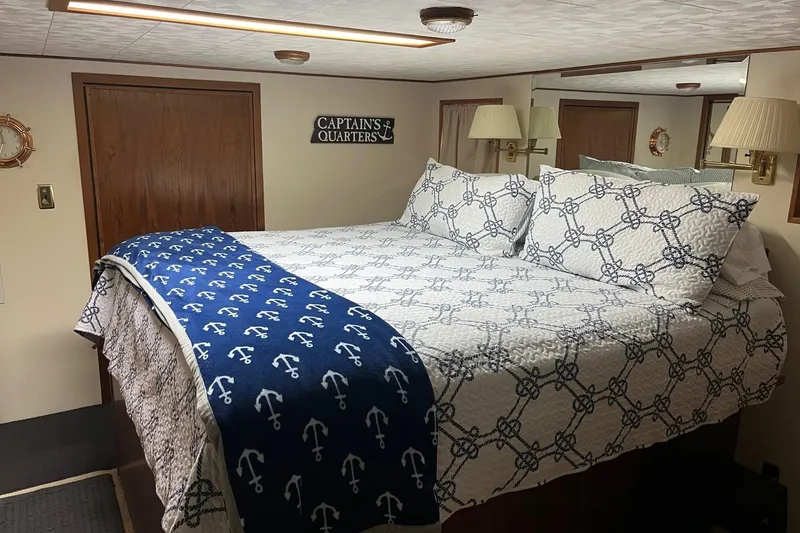Slide: The Image of Cozy bedroom in 1997 Pluckebaum 60 Motor Yacht with nautical-themed bedding. - 8