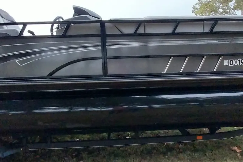 Slide: The Image of 2020 Ranger 2500LS pontoon boat side view with sleek design and railing. - 10