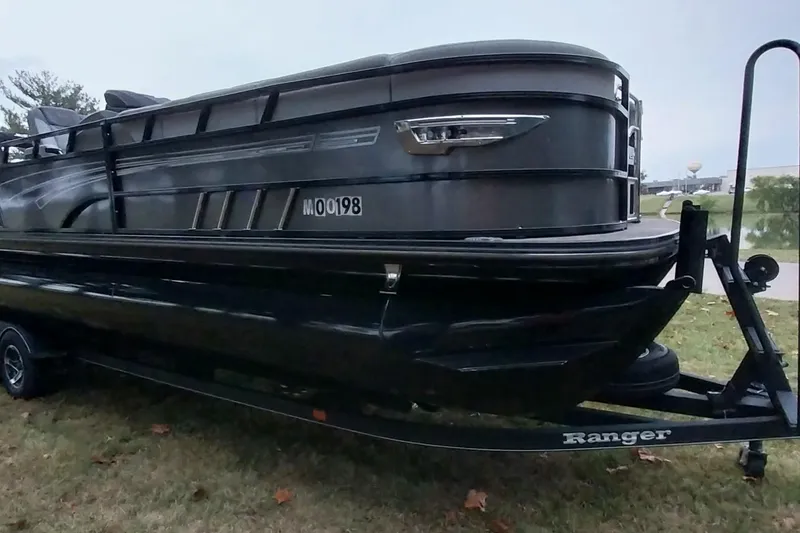 Slide: The Image of 2020 Ranger 2500LS boat on trailer, parked on grass. - 11