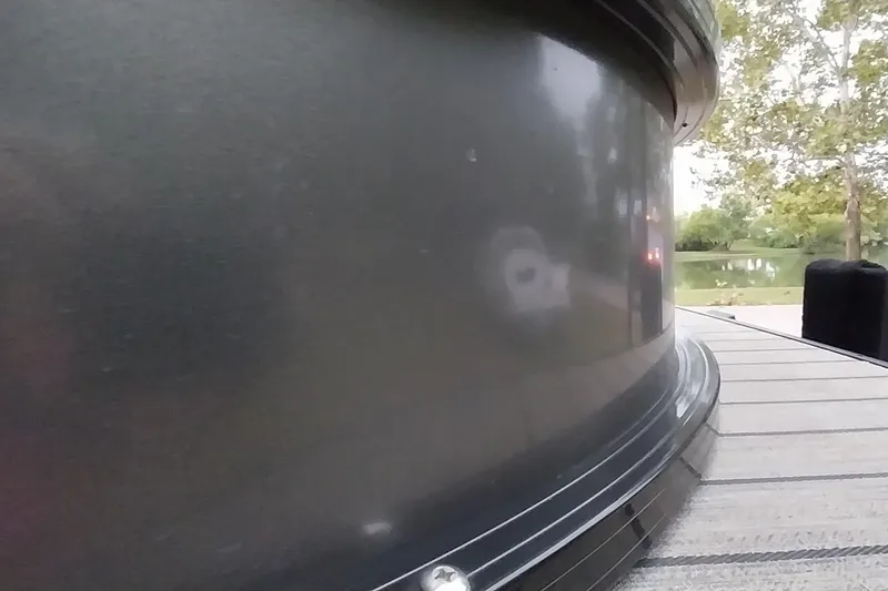 Slide: The Image of Close-up of a 2020 Ranger 2500LS boat detail with a lake and trees in the background. - 13