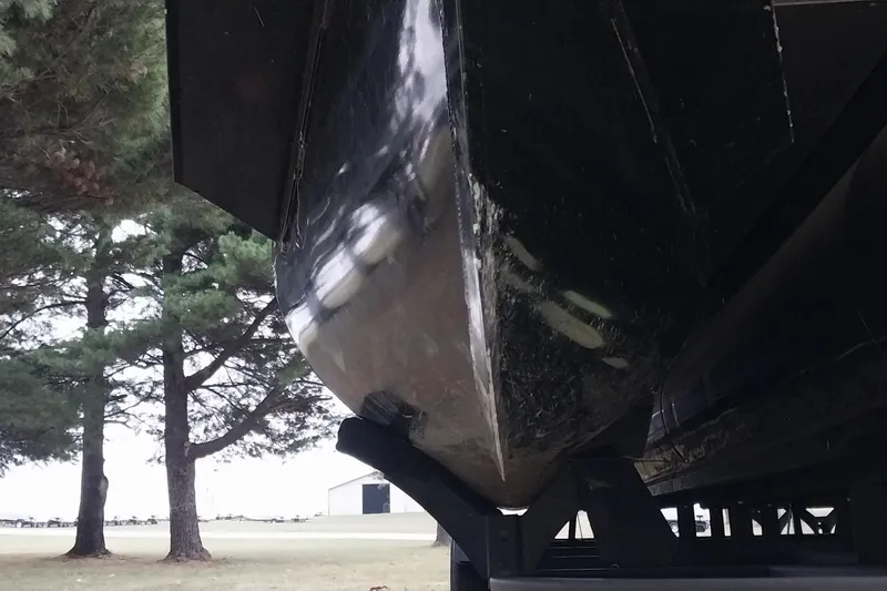 Slide: The Image of 2020 Ranger 2500LS boat hull on trailer, surrounded by trees. - 14