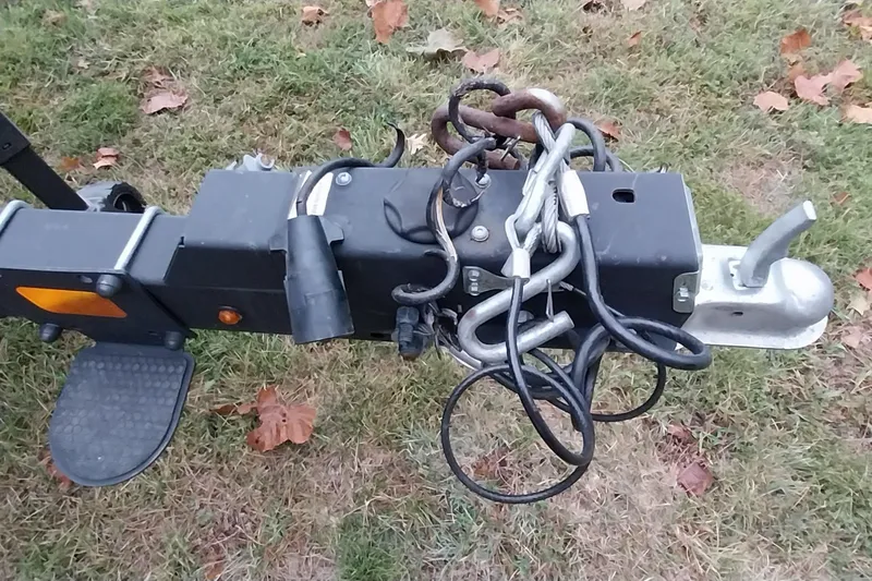 Slide: The Image of Trailer hitch of a 2020 Ranger 2500LS on grass with safety chains and cables. - 18