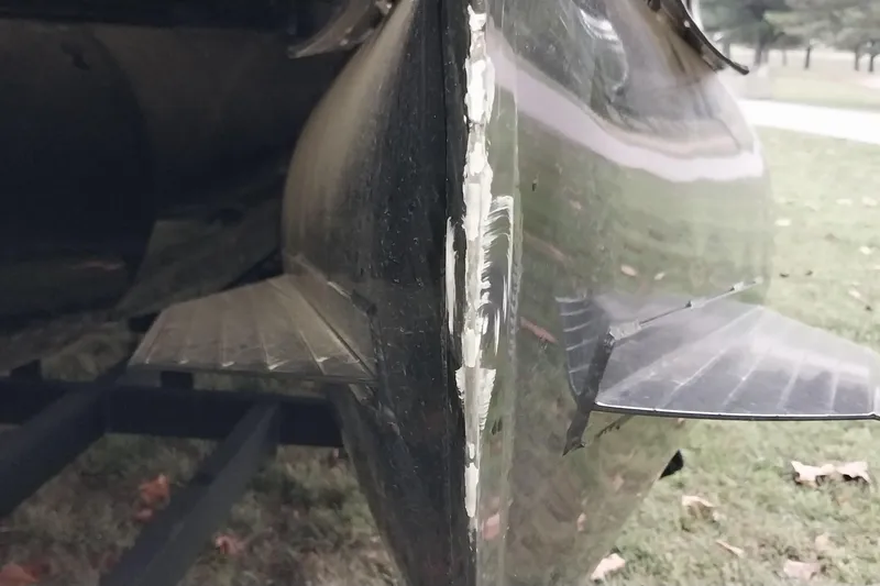 Slide: The Image of 2020 Ranger 2500LS boat hull with visible damage and scratches on the side. - 20