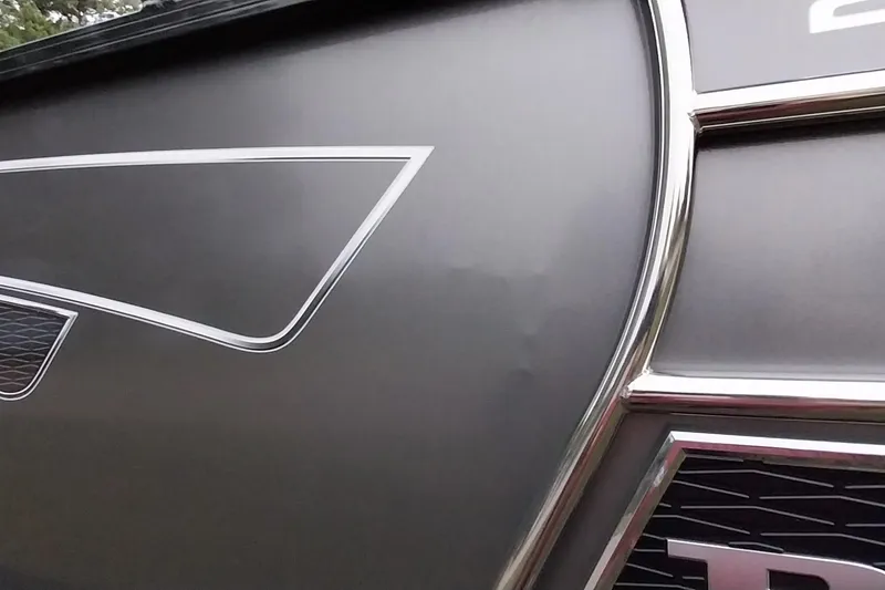 Slide: The Image of Close-up of 2020 Ranger 2500LS boat with sleek metallic design and chrome accents. - 29