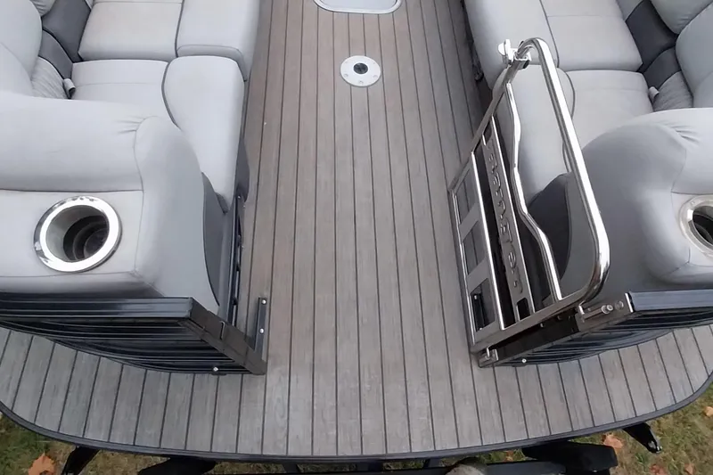 Slide: The Image of 2020 Ranger 2500LS boat interior with gray seating and wood-style flooring. - 35