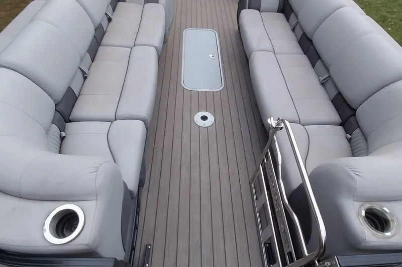 Slide: The Image of 2020 Ranger 2500LS boat interior with gray seating and wood-style flooring. - 36