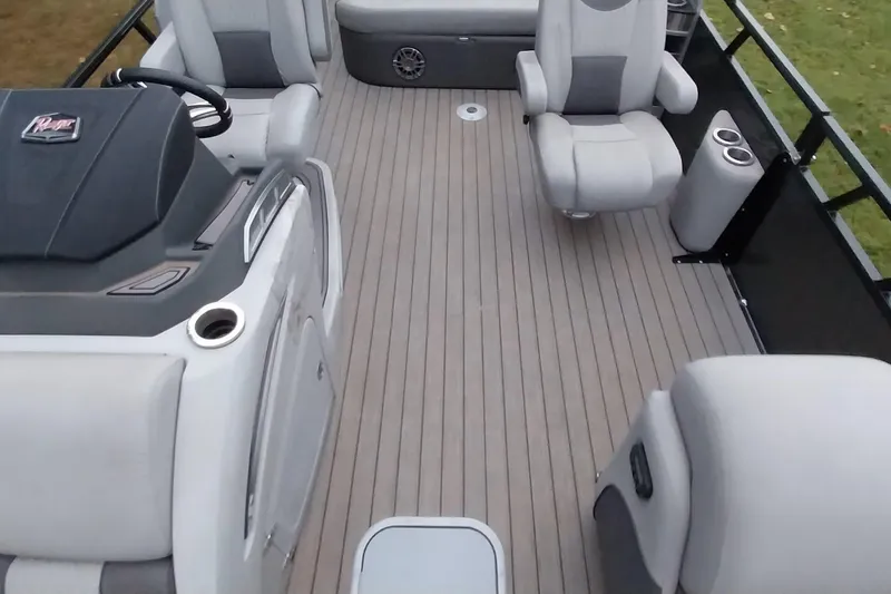 Slide: The Image of 2020 Ranger 2500LS boat interior with gray seating and steering console. - 39