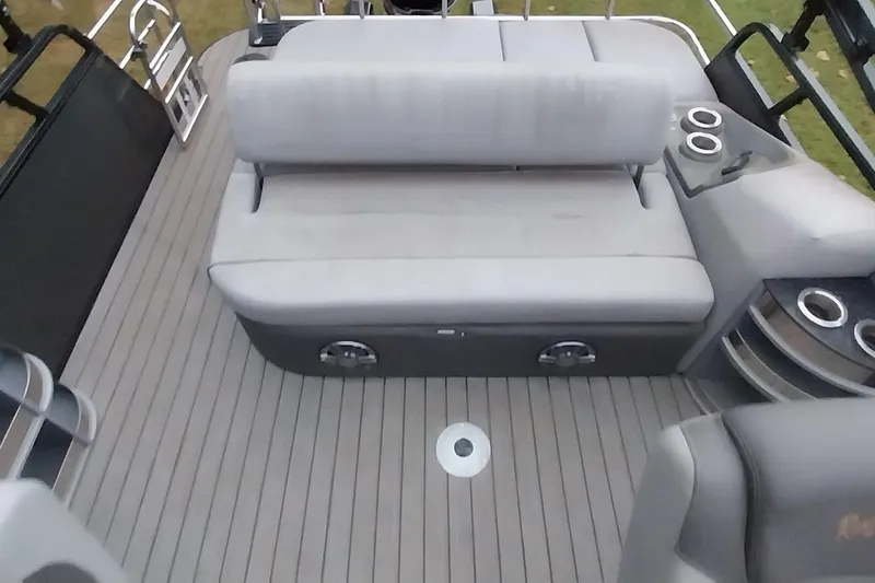 Slide: The Image of 2020 Ranger 2500LS boat interior with gray seating and cup holders. - 42