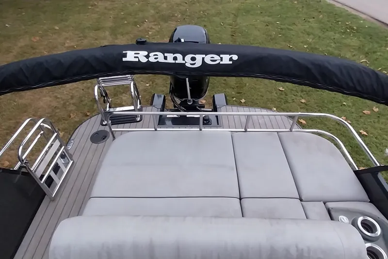Slide: The Image of 2020 Ranger 2500LS boat with cushioned seating and railing, viewed from above. - 44