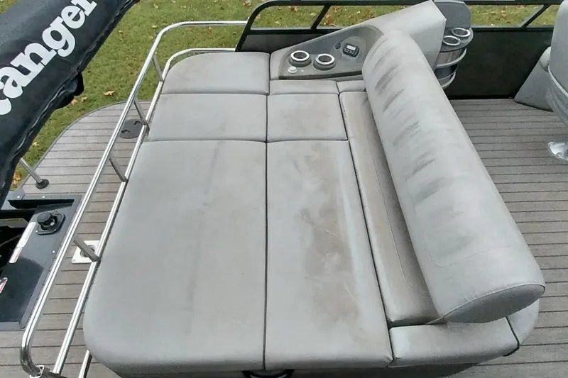 Slide: The Image of Ranger 2500LS 2020 boat seating area with cup holders and railing. - 46