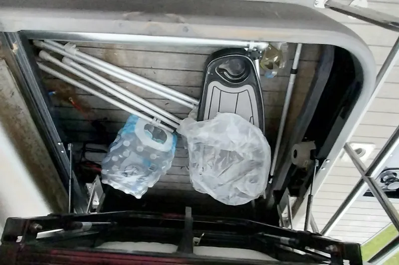 Slide: The Image of Storage compartment of a 2020 Ranger 2500LS with folded poles and a plastic bag. - 47
