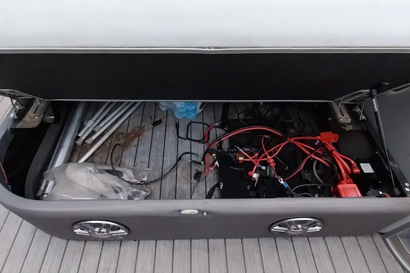 Slide: The Image of Open storage compartment in 2020 Ranger 2500LS boat, showing wiring and equipment. - 49