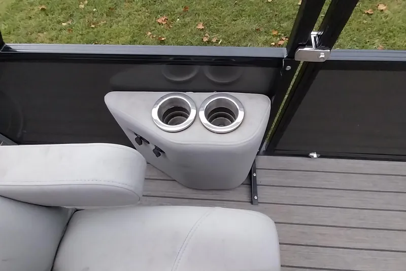 Slide: The Image of 2020 Ranger 2500LS boat interior with cup holders and seating on deck. - 52