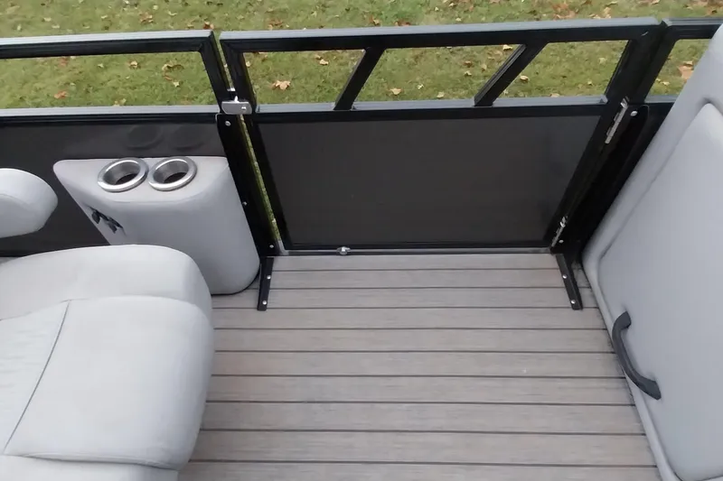 Slide: The Image of 2020 Ranger 2500LS boat interior with seating, cup holders, and railing. - 53