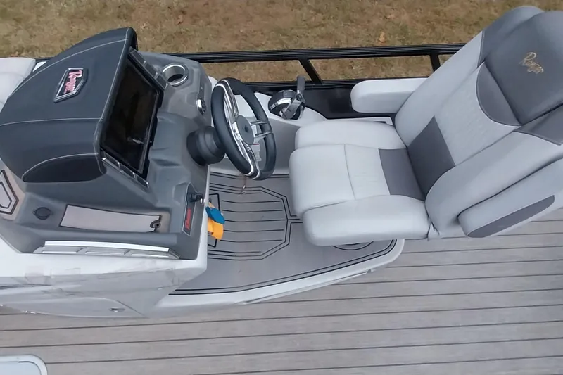 Slide: The Image of Captain's seat and helm of 2020 Ranger 2500LS boat, featuring modern controls and comfortable seating. - 54