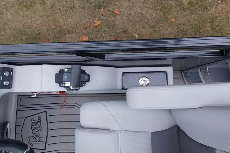 Slide: The Image of Interior view of a 2020 Ranger 2500LS boat, featuring controls and seating. - 56