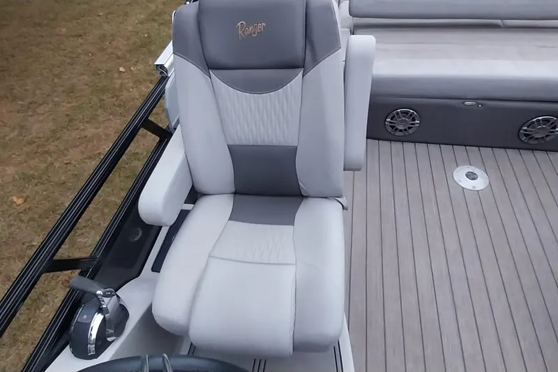 Slide: The Image of Ranger 2500LS 2020 boat seat with gray upholstery and armrests on deck. - 57