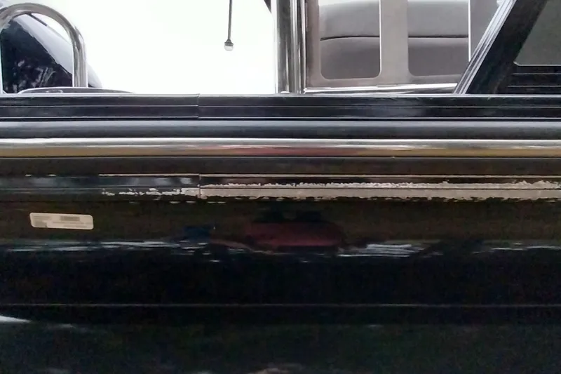 Slide: The Image of 2020 Ranger 2500LS boat with visible wear on the side panel. - 6