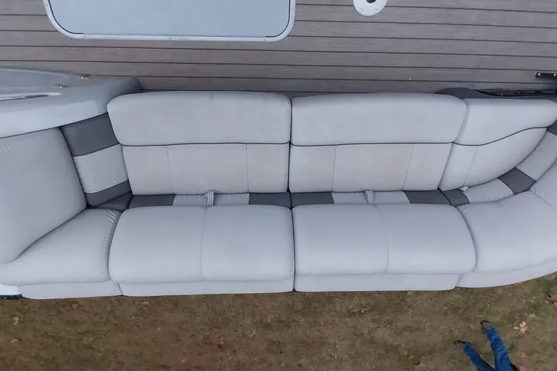 Slide: The Image of 2020 Ranger 2500LS boat interior with spacious, cushioned seating in neutral tones. - 62