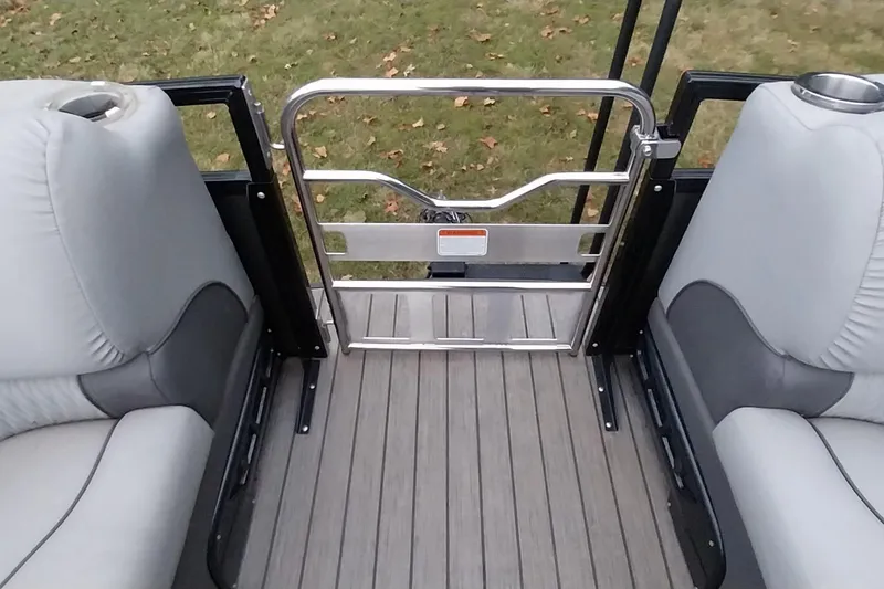 Slide: The Image of 2020 Ranger 2500LS boat interior with gray seating and metal gate. - 64