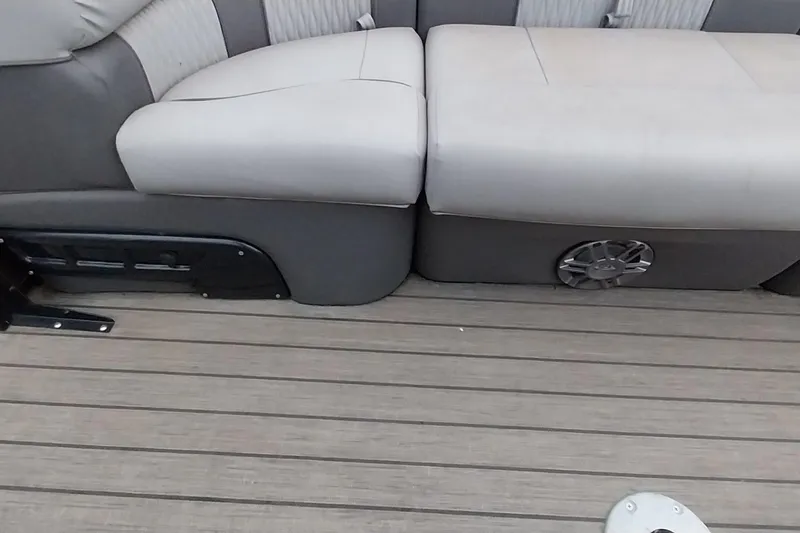 Slide: The Image of 2020 Ranger 2500LS boat interior with gray seating and wood-textured flooring. - 66