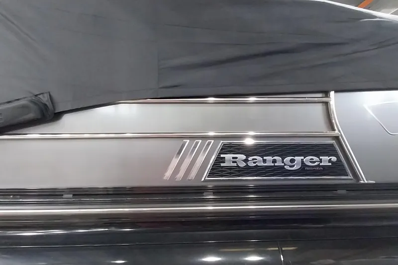 Slide: The Image of 2020 Ranger 2500LS boat with sleek metallic design partially covered. - 73