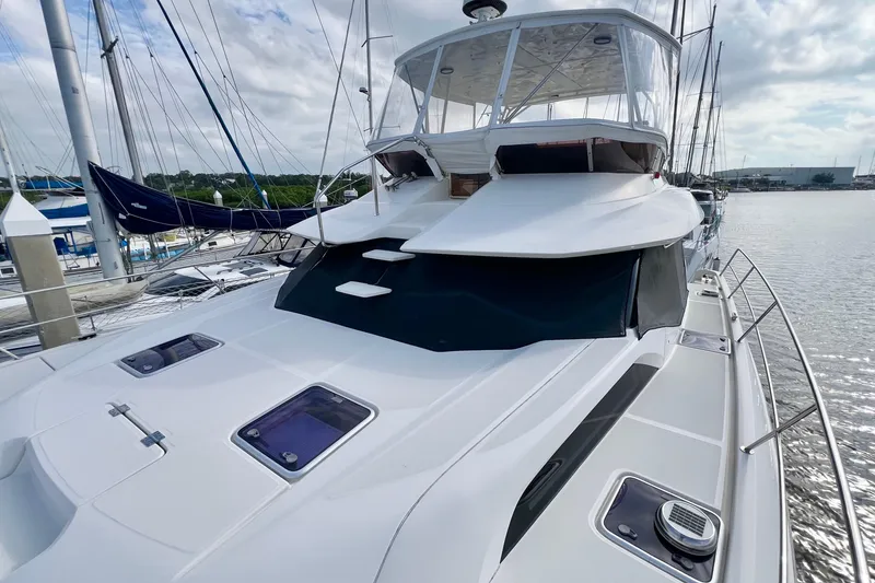 Slide: The Image of 2019 Aquila 44 yacht docked at marina, showcasing sleek design and spacious deck. - 10