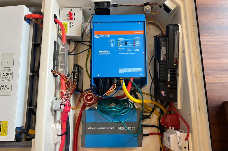 Slide: The Image of Battery compartment of a 2019 Aquila 44 with wiring and connections visible. - 102