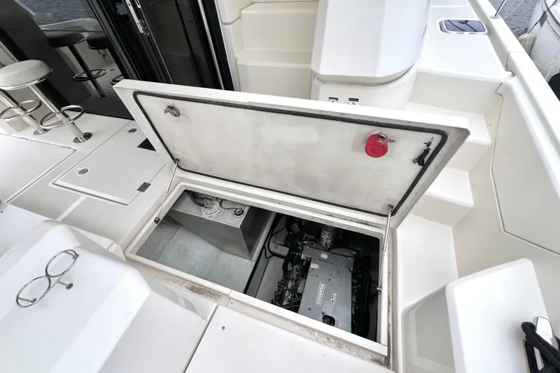 Slide: The Image of Storage compartment on Aquila 44 yacht, 2019 model, with open hatch and wooden flooring. - 104