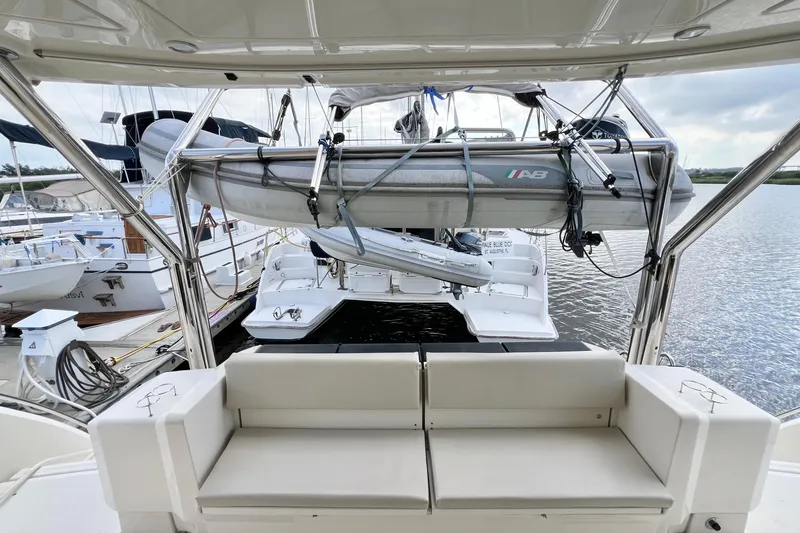 Slide: The Image of Aquila 44 yacht interior with docked boats and inflatable dinghy, 2019 model. - 15