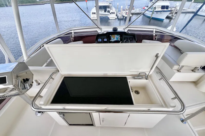 Slide: The Image of Flybridge of 2019 Aquila 44 yacht with open sink and marina view. - 22