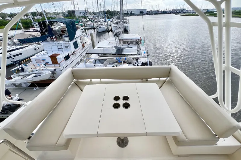 Slide: The Image of Aquila 44 yacht deck with seating and table, docked at marina, 2019 model. - 24
