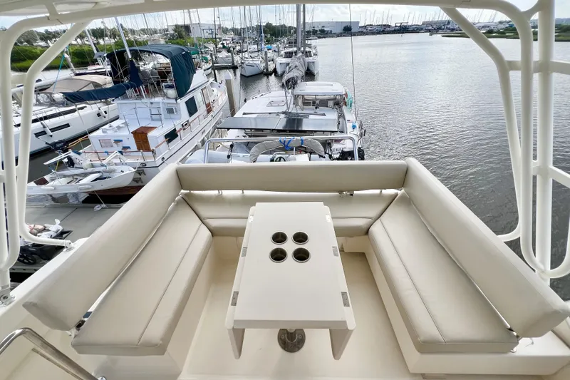 Slide: The Image of Aquila 44 yacht's seating area with table, docked at marina, 2019 model. - 25