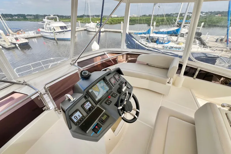 Slide: The Image of Cockpit of 2019 Aquila 44 yacht with modern navigation system and marina view. - 29