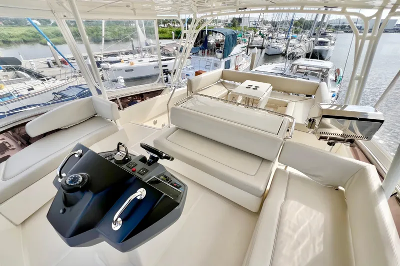 Slide: The Image of Luxurious 2019 Aquila 44 yacht interior with helm, seating, and marina view. - 33