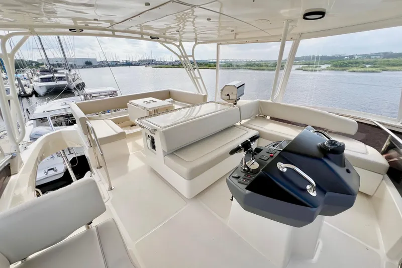 Slide: The Image of Luxurious 2019 Aquila 44 yacht interior with helm, seating, and scenic marina view. - 34
