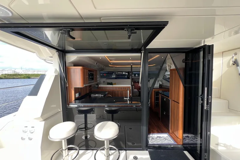 Slide: The Image of Luxurious 2019 Aquila 44 yacht interior with modern kitchen and bar stools. - 37