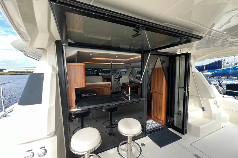 Slide: The Image of Luxurious 2019 Aquila 44 yacht interior with modern kitchen and bar stools. - 38