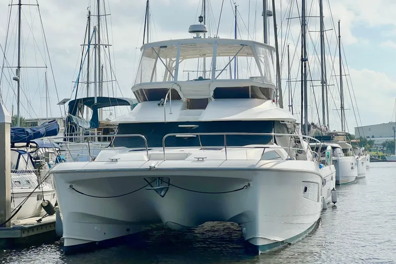 Slide: The Image of 2019 Aquila 44 yacht docked at marina, surrounded by sailboats. - 4