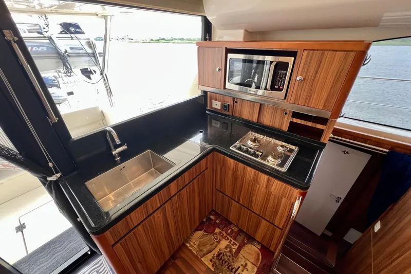 Slide: The Image of Luxurious 2019 Aquila 44 yacht kitchen with modern appliances and sleek wood finish. - 45
