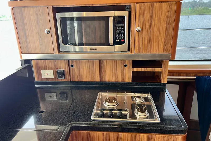 Slide: The Image of Modern kitchen in 2019 Aquila 44 yacht with microwave and stovetop. - 48