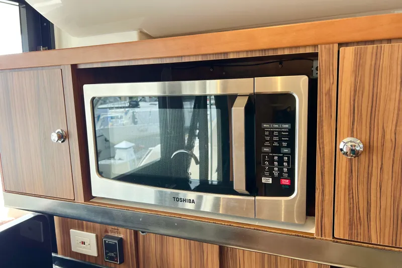 Slide: The Image of Built-in Toshiba microwave in 2019 Aquila 44 yacht kitchen cabinetry. - 49