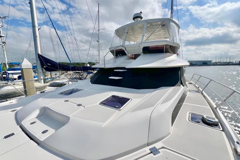 Slide: The Image of 2019 Aquila 44 yacht docked at marina under a partly cloudy sky. - 5