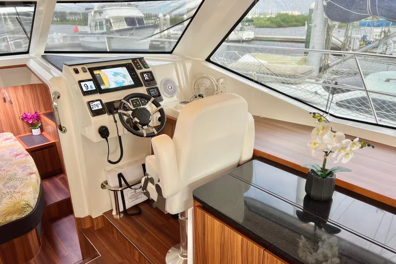 Slide: The Image of Luxurious 2019 Aquila 44 yacht interior with modern helm, floral decor, and panoramic windows. - 53