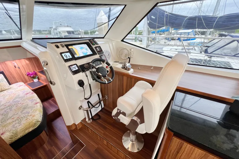 Slide: The Image of Helm station of 2019 Aquila 44 yacht with modern navigation equipment and luxurious seating. - 54