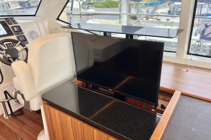 Slide: The Image of Interior of 2019 Aquila 44 yacht with helm, TV, and modern controls. - 59